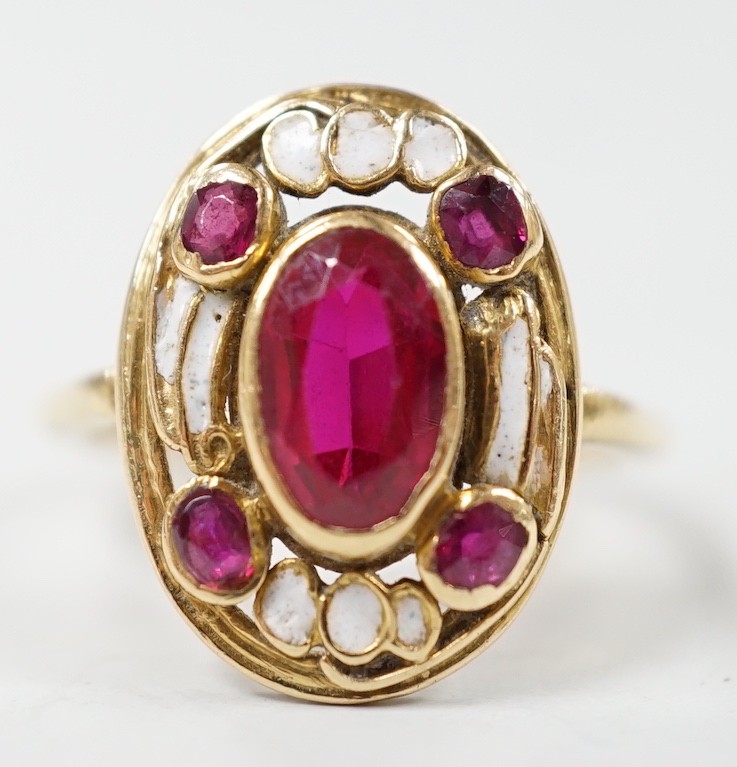 An 18ct, white enamel and four stone synthetic? ruby set oval dress ring, size N, gross weight 3.9 grams.